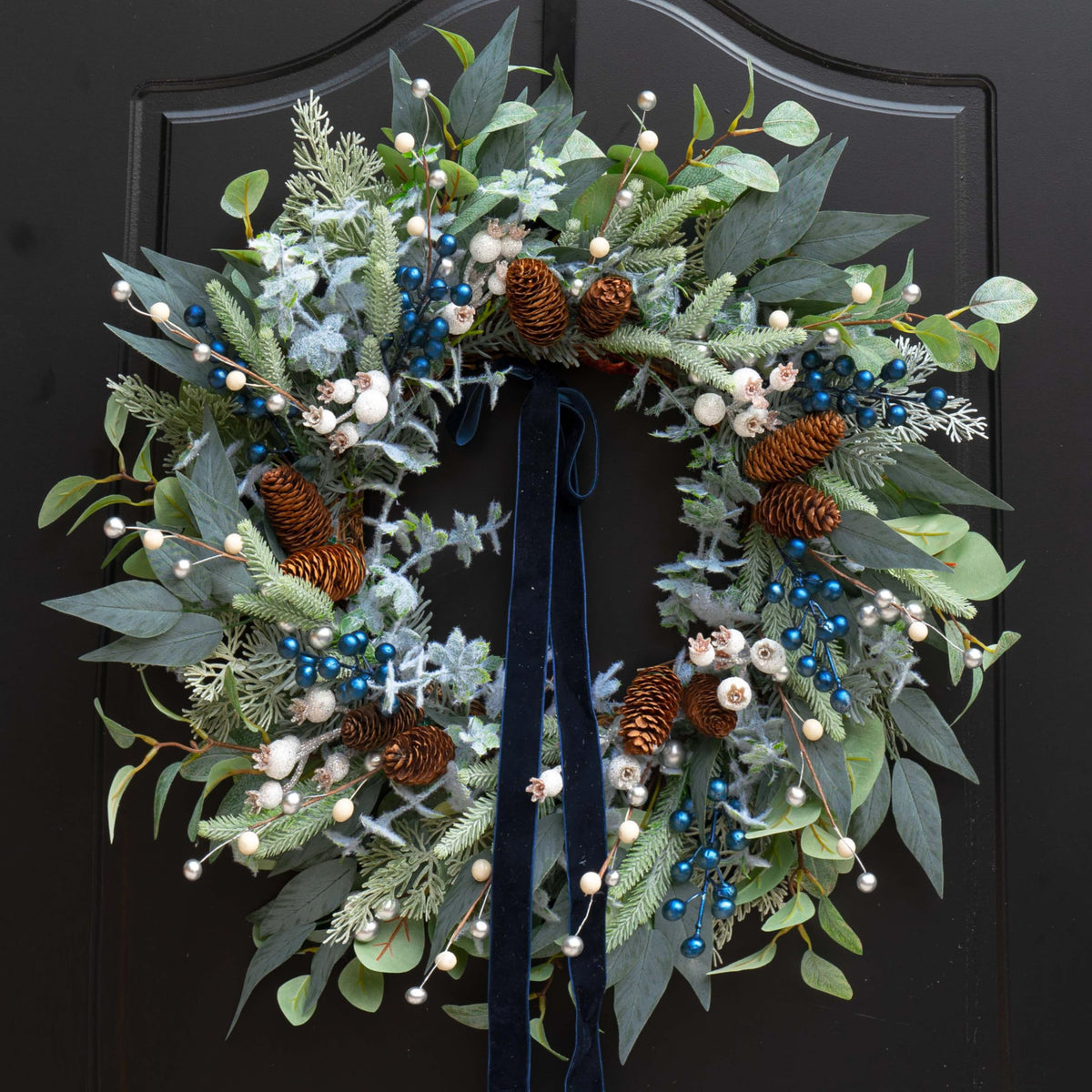 ArcadiaArt front view wreath showing full greenery and winter accents for curb appeal