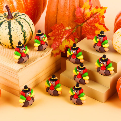 ARCHCRTC all 50 mini turkey figurines spread out displaying variety and party-ready supply