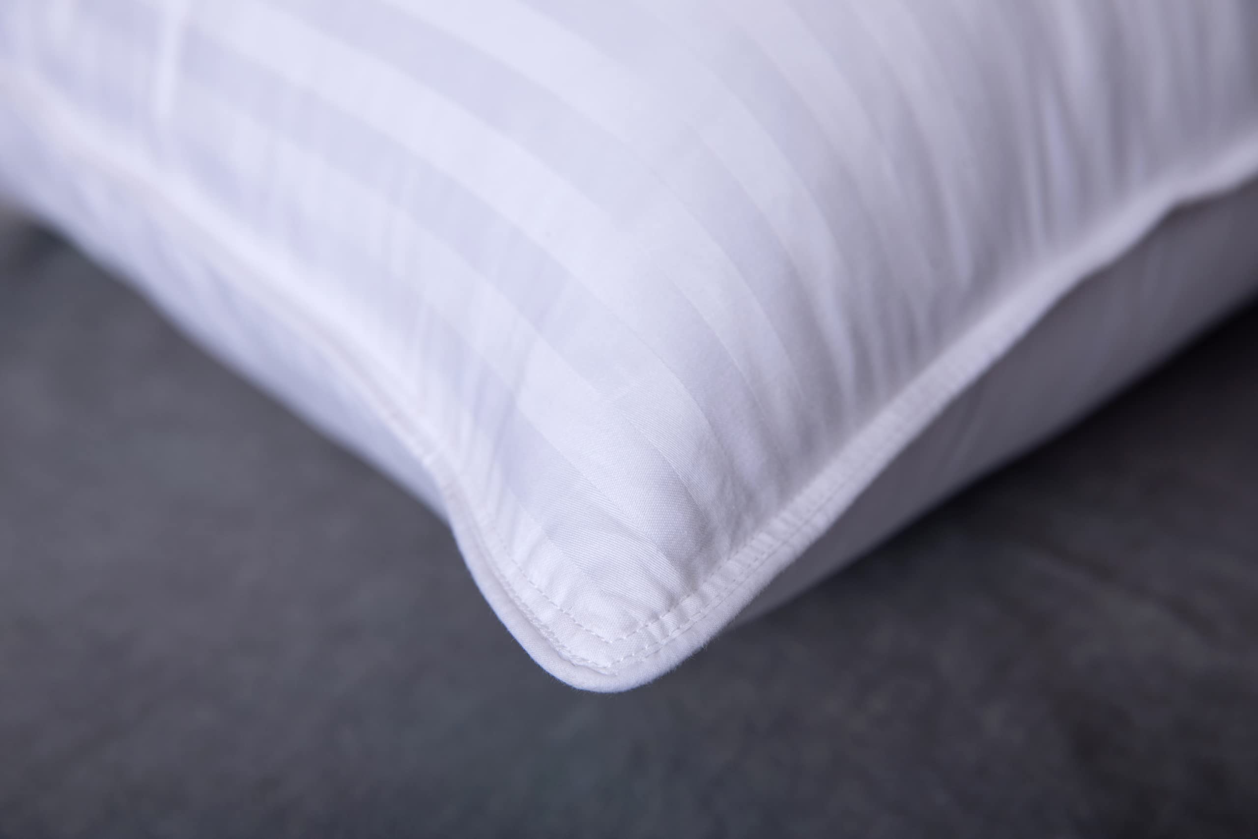 ArcticNorthDown pillow on made bed in lifestyle scene demonstrating plush hotel-style comfort