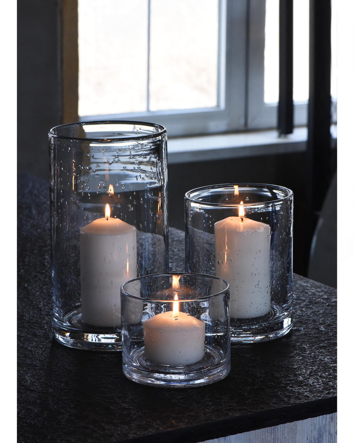 ARIAMOTION front view of three glass cylinders creating layered centerpiece