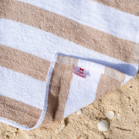 Arkwright Cali Cabana folded stack beside sunglasses showing size and storage-friendly benefit