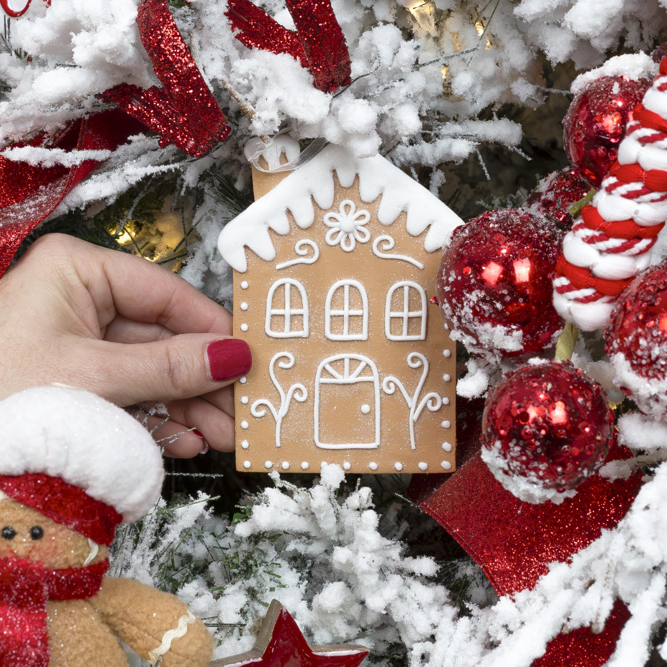 AuldHome Design group of gingerbread houses on tree creating cozy cohesive holiday focal point