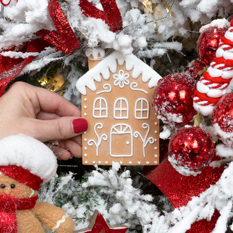 AuldHome Design group of gingerbread houses on tree creating cozy cohesive holiday focal point