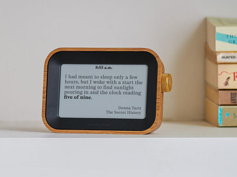 Author Clock on a desk with books and mug, Author design elevates reading corners