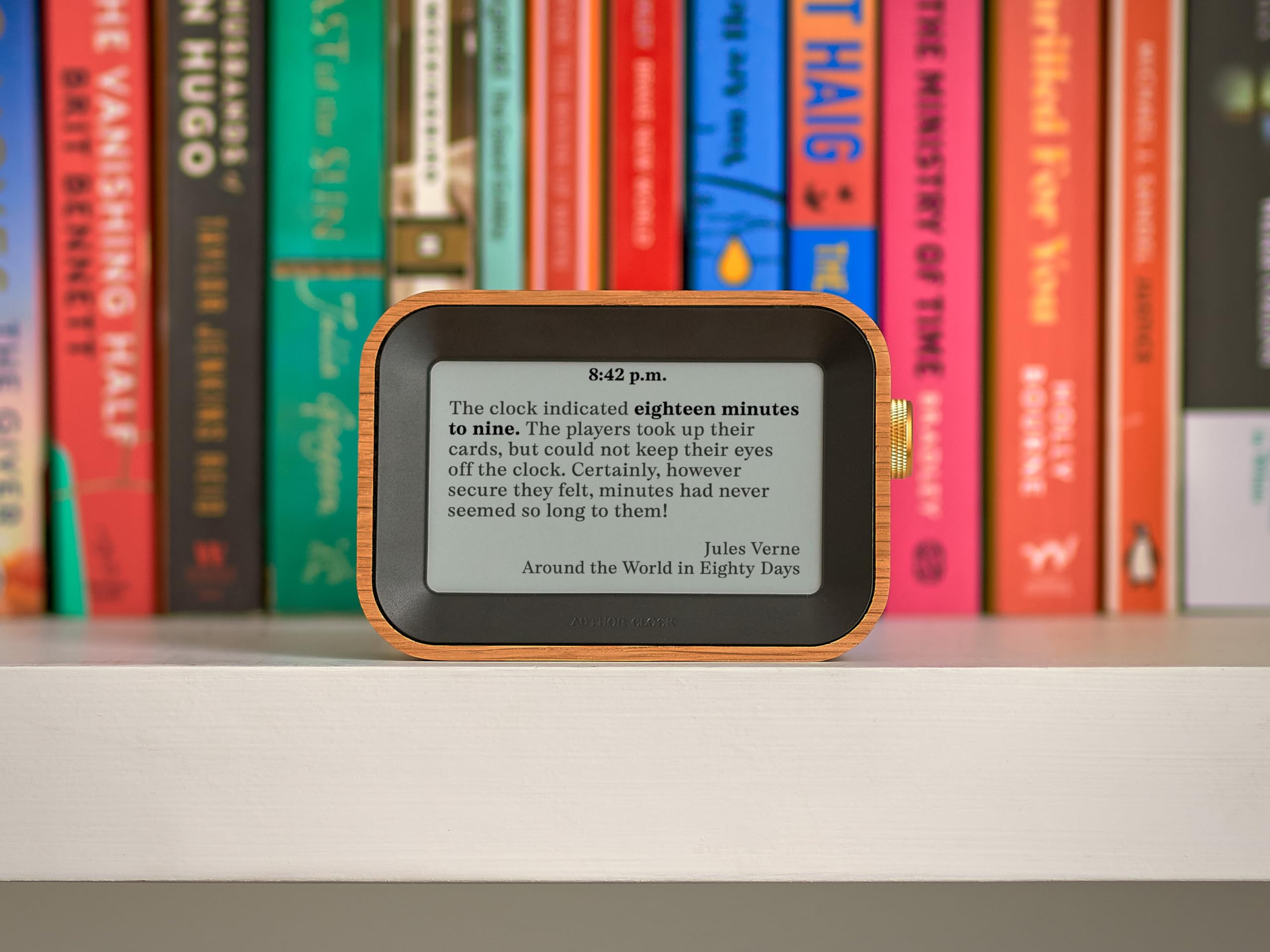 Author Clock held in hand to show scale, Author compact size fits any desk