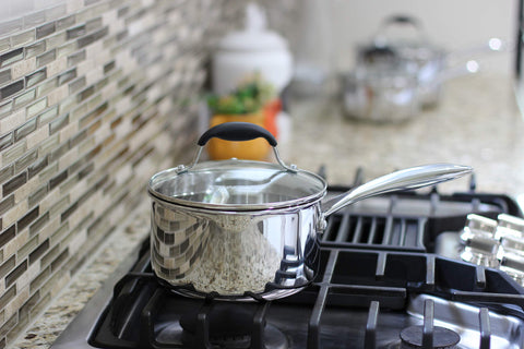 AVACRAFT saucepan being loaded into dishwasher showing easy cleanup benefit
