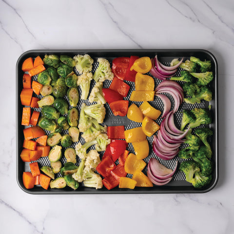 Baker's Secret baking sheets styled on counter suggesting everyday use