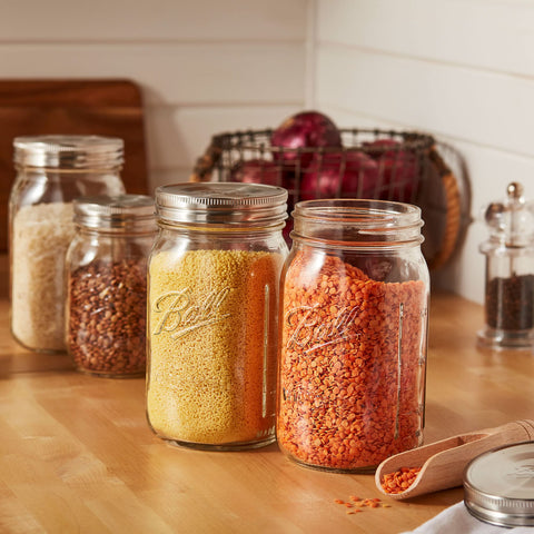 Ball lids stacked on a wide-mouth jar demonstrating organized storage benefit