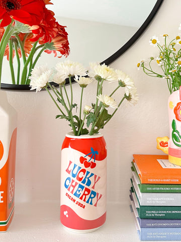 ban.do on a shelf in a living space adding whimsical accent and style benefit