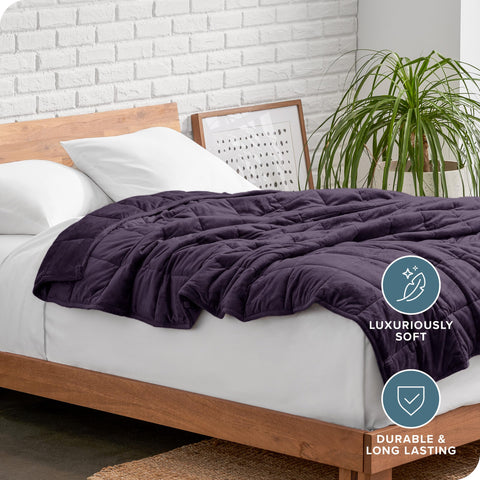 Bare Home blanket styled on a bed conveying a warm, restful bedroom setting