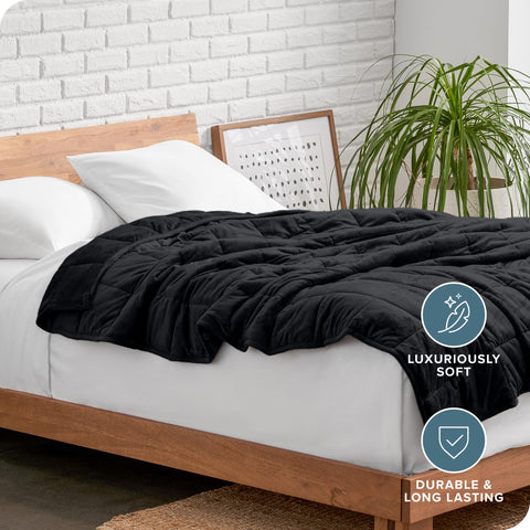 Bare Home lifestyle shot of blanket spread on bed illustrating cozy bedroom setting