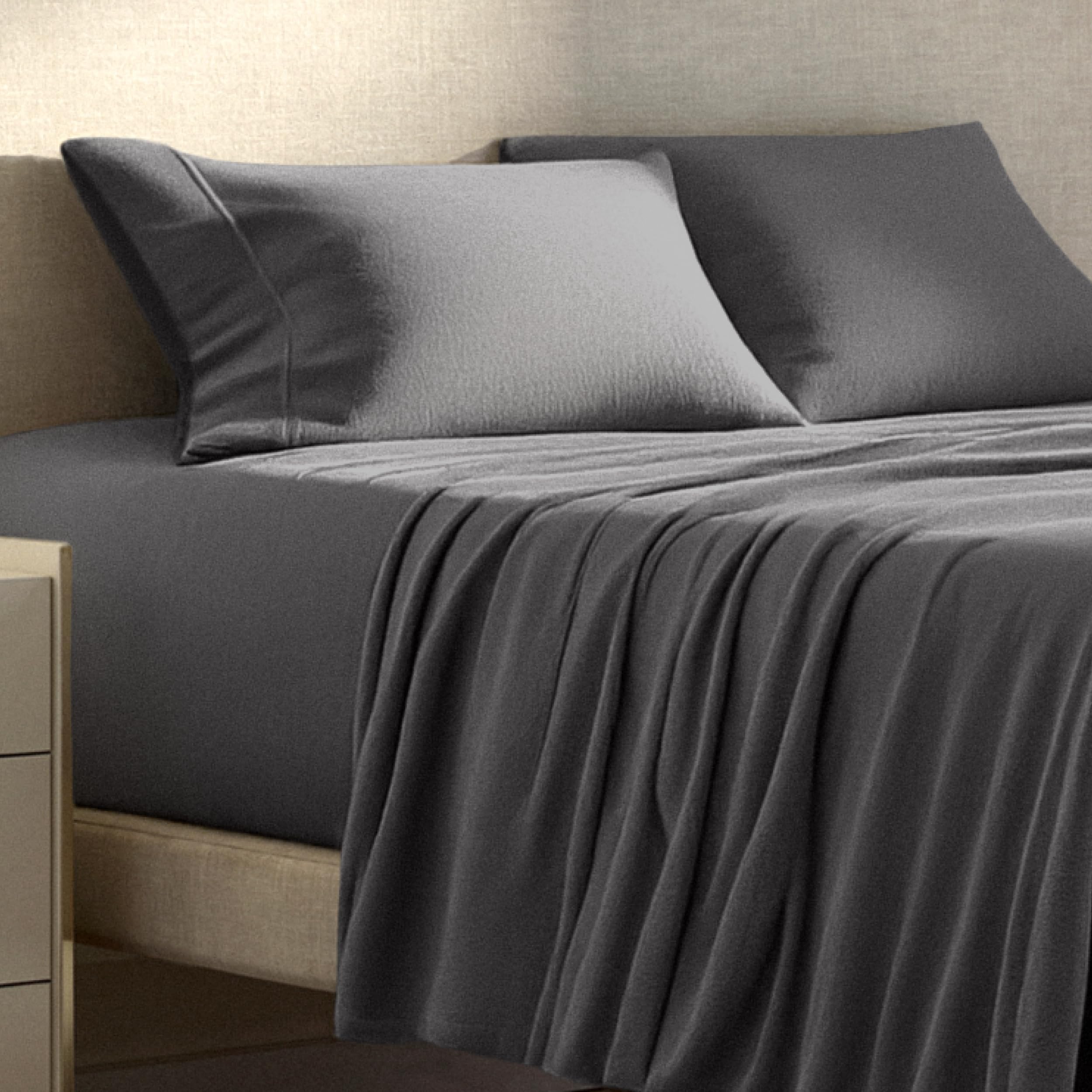 Bare Home sheet next to ruler and mattress to show size and depth compatibility