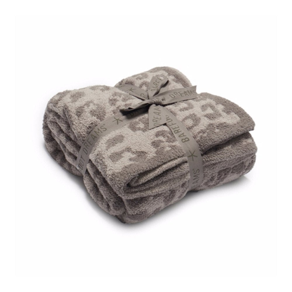 Barefoot Dreams throw front display showing leopard linen warm gray pattern and gifting bow, stylish accent