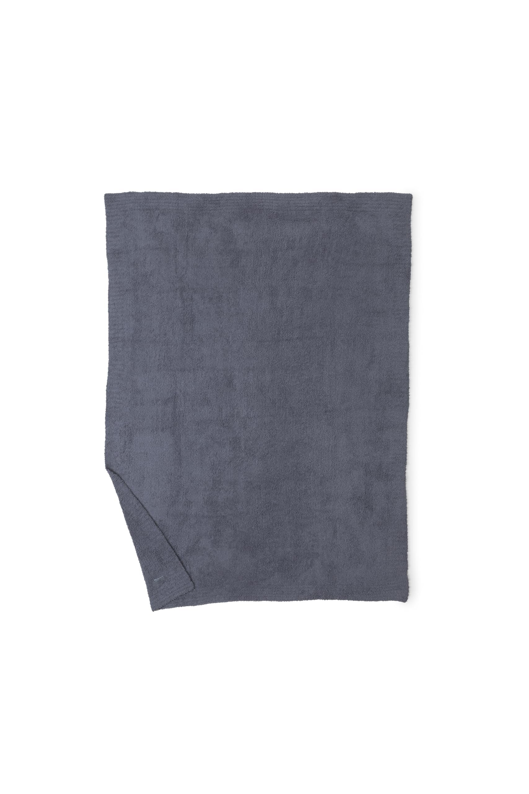 Barefoot Dreams draped over sofa illustrating instant room warmth and modern neutral accent