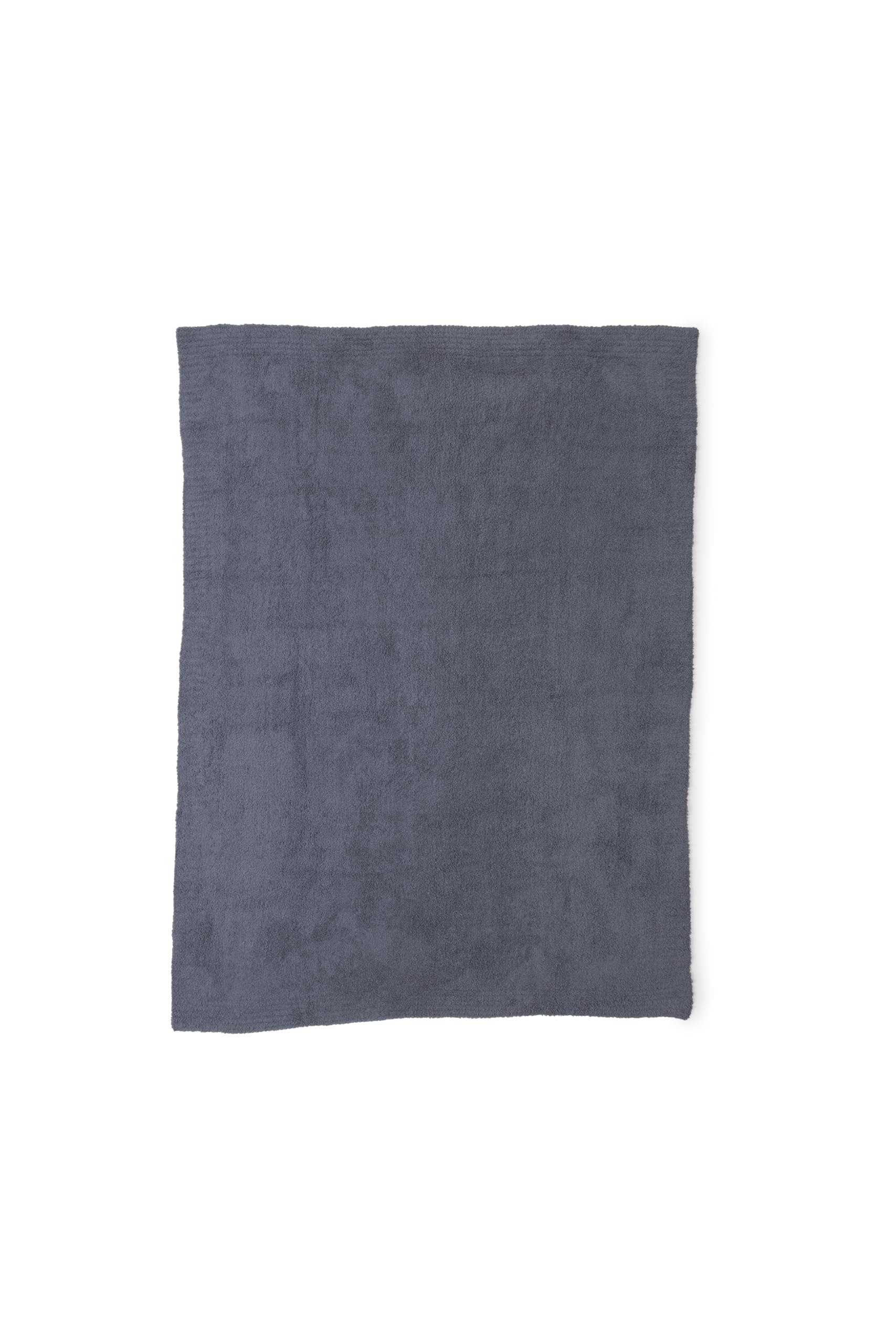 Barefoot Dreams folded throw on bed demonstrating compact storage and elegant layering benefit