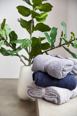Barefoot Dreams folded throw on shelf illustrating tidy storage and neat styling