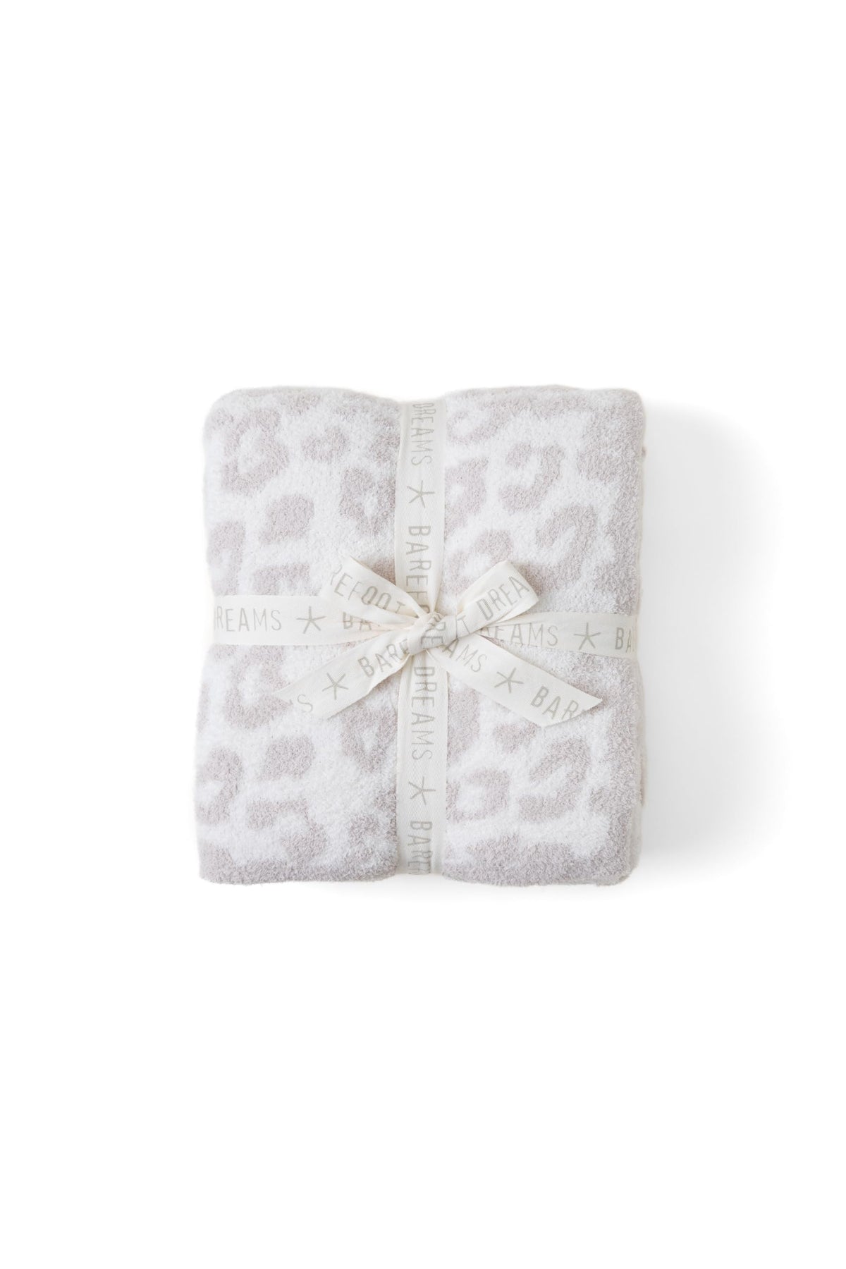 Barefoot Dreams throw front view showing cream-stone animal jacquard and cozy look