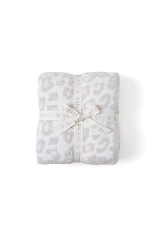 Barefoot Dreams throw front view showing cream-stone animal jacquard and cozy look
