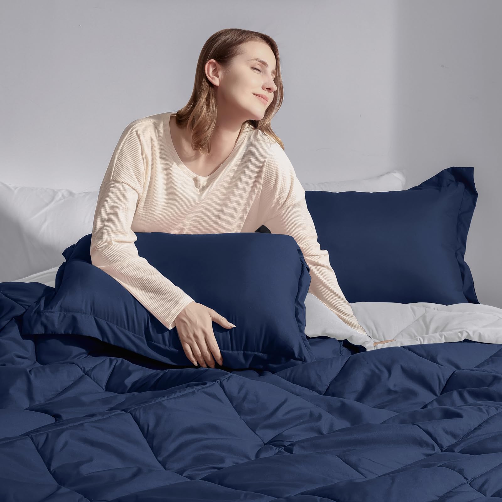 Basic Beyond comforter on styled bed showing how it upgrades a room benefit