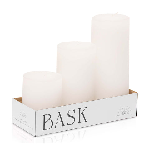 Bask front view of three white pillar candles showing clean design and gift-ready look