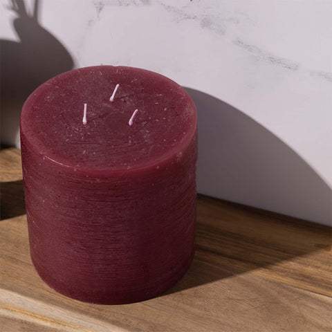 Bask candle next to hand for scale showing substantial 6-inch diameter