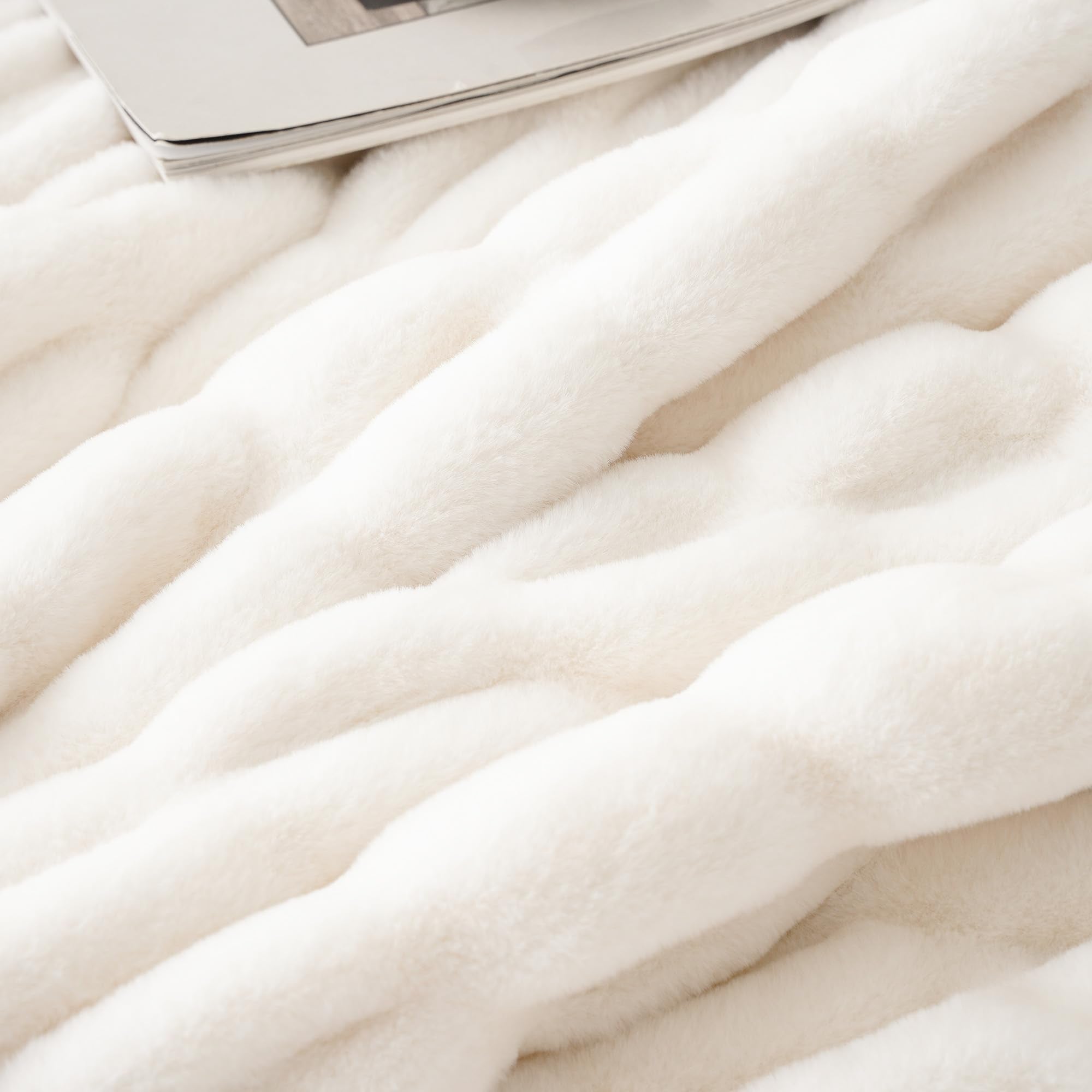 BATTILO HOME folded throw on bed footboard for neat decorative layering