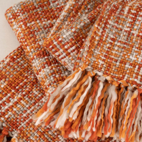 BATTILO HOME folded throw in a stack demonstrating neat storage and color pop