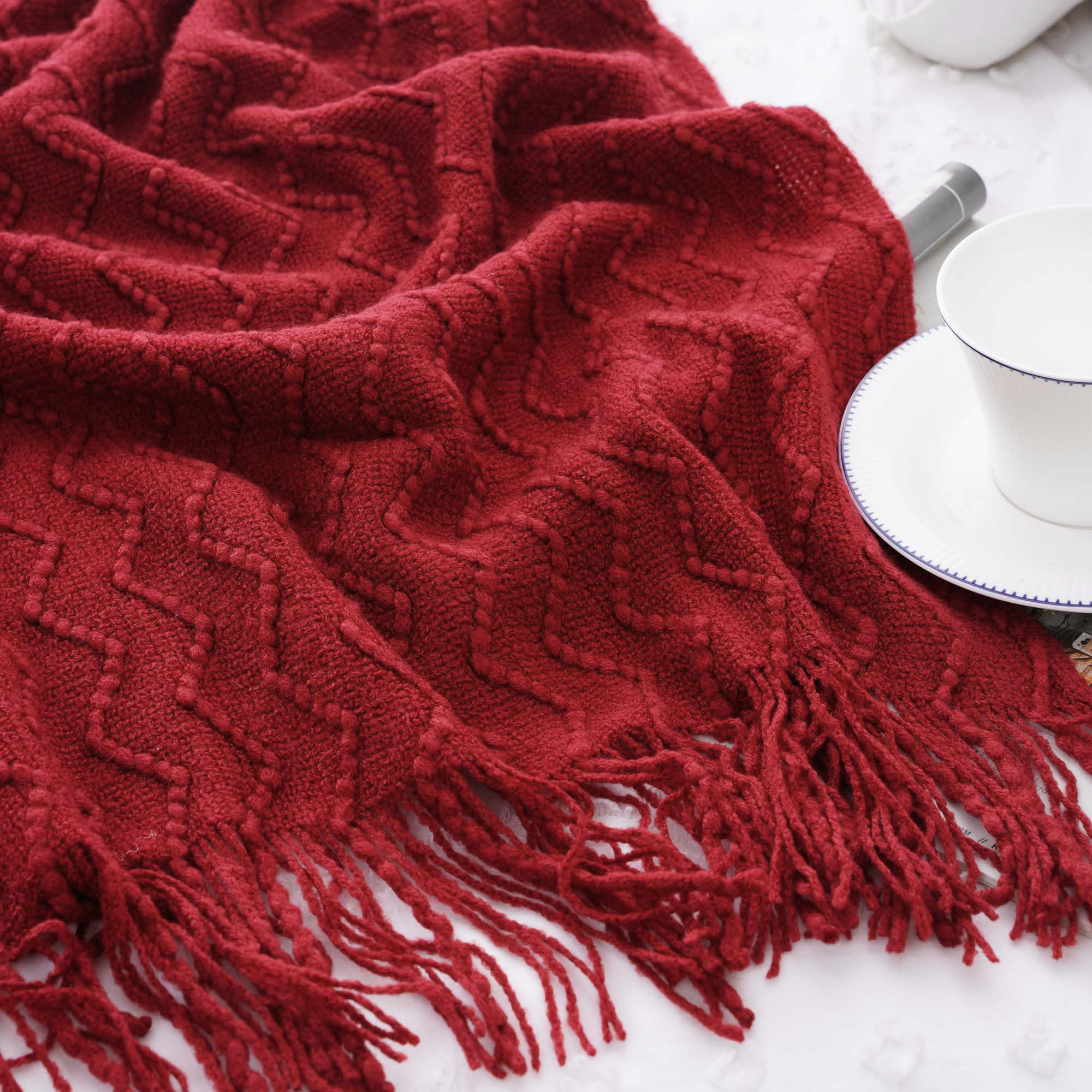 BATTILO HOME blanket beside chair illustrating 50x60 size and convenient scale for sofas