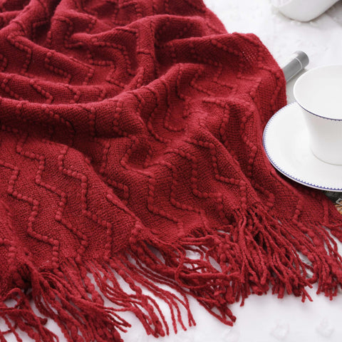 BATTILO HOME blanket beside chair illustrating 50x60 size and convenient scale for sofas