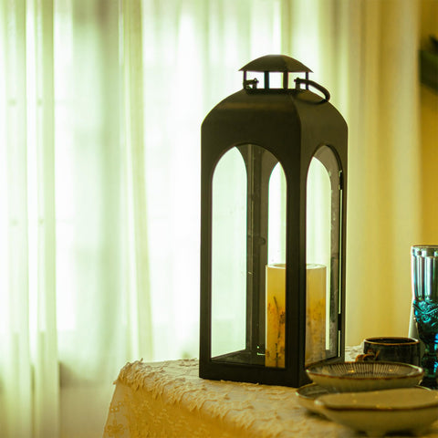 Bdor lanterns flanking fireplace adding symmetrical decorative impact