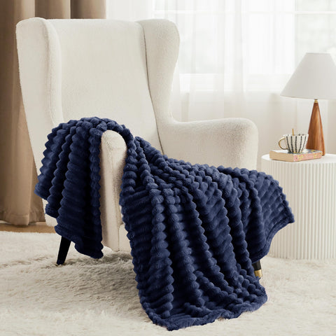 Bedsure navy blanket draped on sofa offering instant warmth and visual depth
