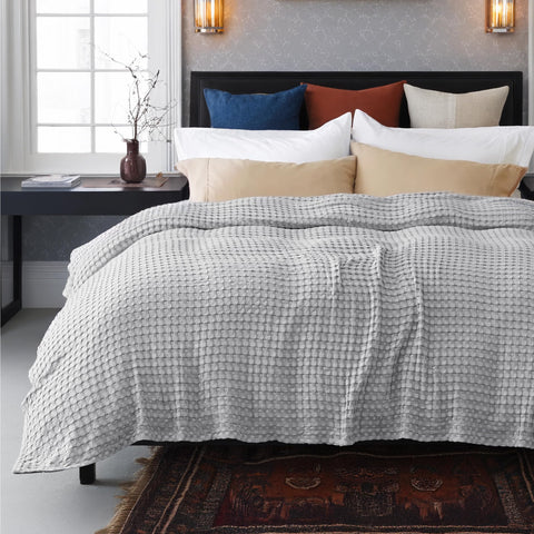 Bedsure fabric held by hand demonstrating lightweight stretch and softness