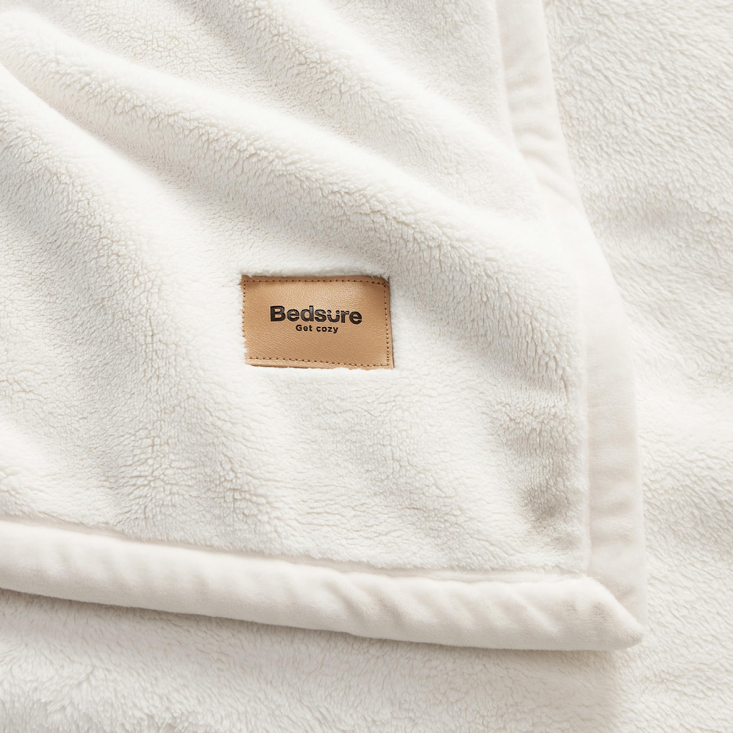 Bedsure blanket folded near laundry basket for easy care