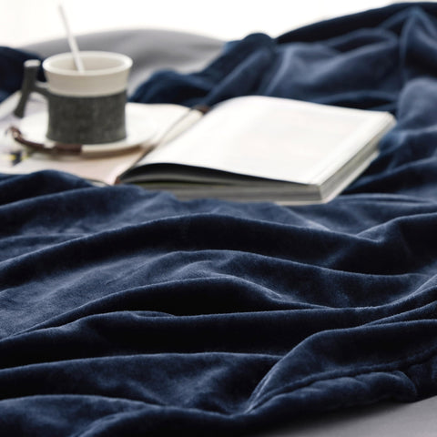 Bedsure blanket draped on couch in use, providing cozy warmth while lounging