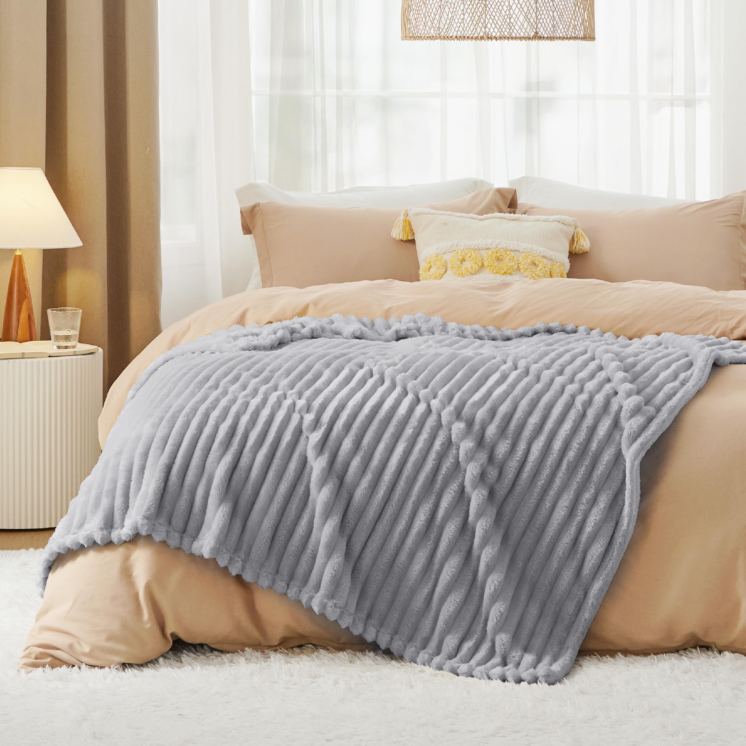 Bedsure blanket held in hand for scale showing generous twin 60x80 size