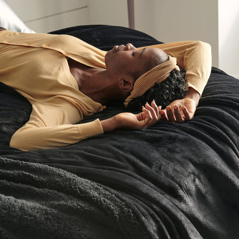 Bedsure blanket on bed illustrating 60x80 inch twin scale