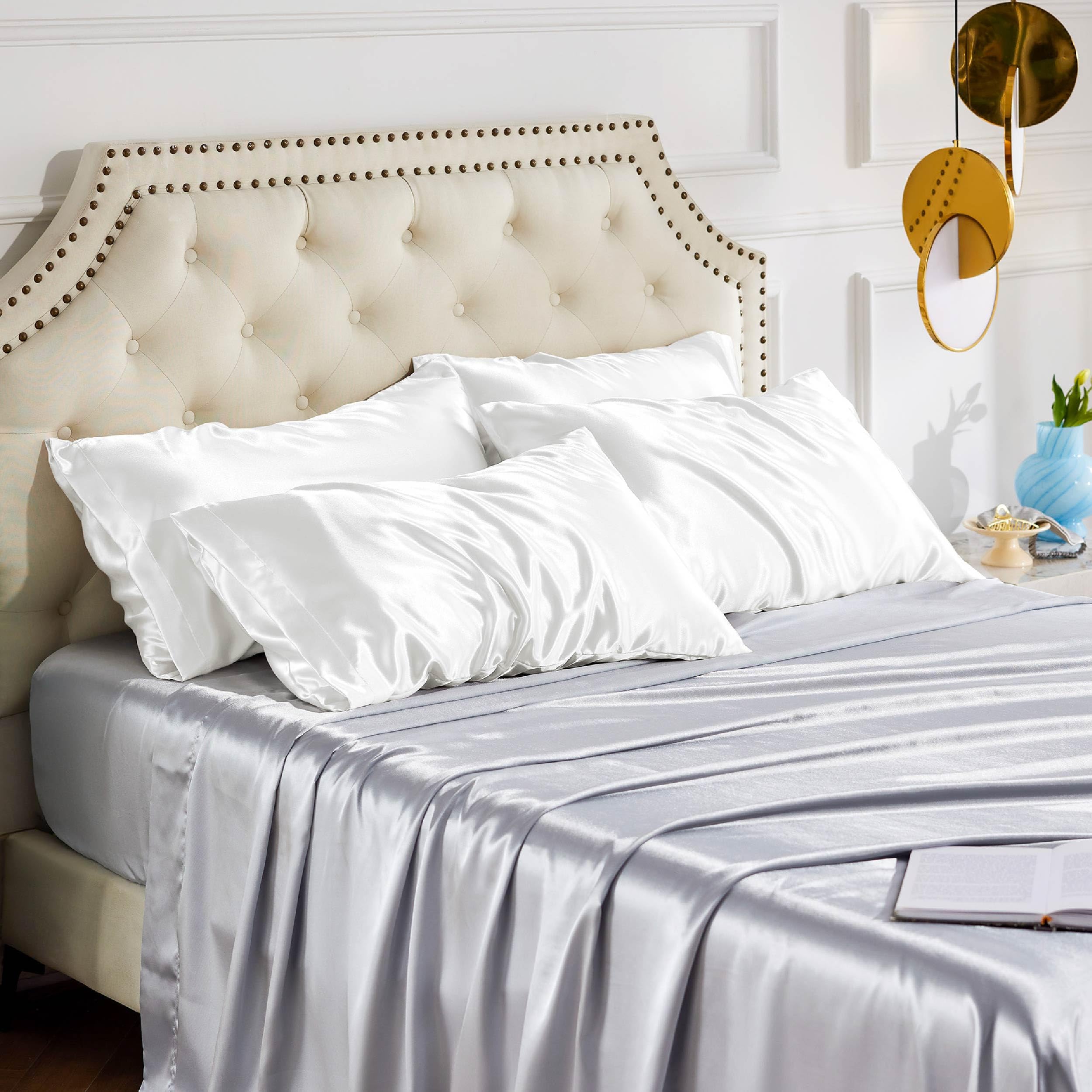 Bedsure hand touching fabric to show soft satin feel and gentle skin benefit
