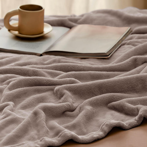 Bedsure GentleSoft on a couch in use conveying comfortable lounging benefit