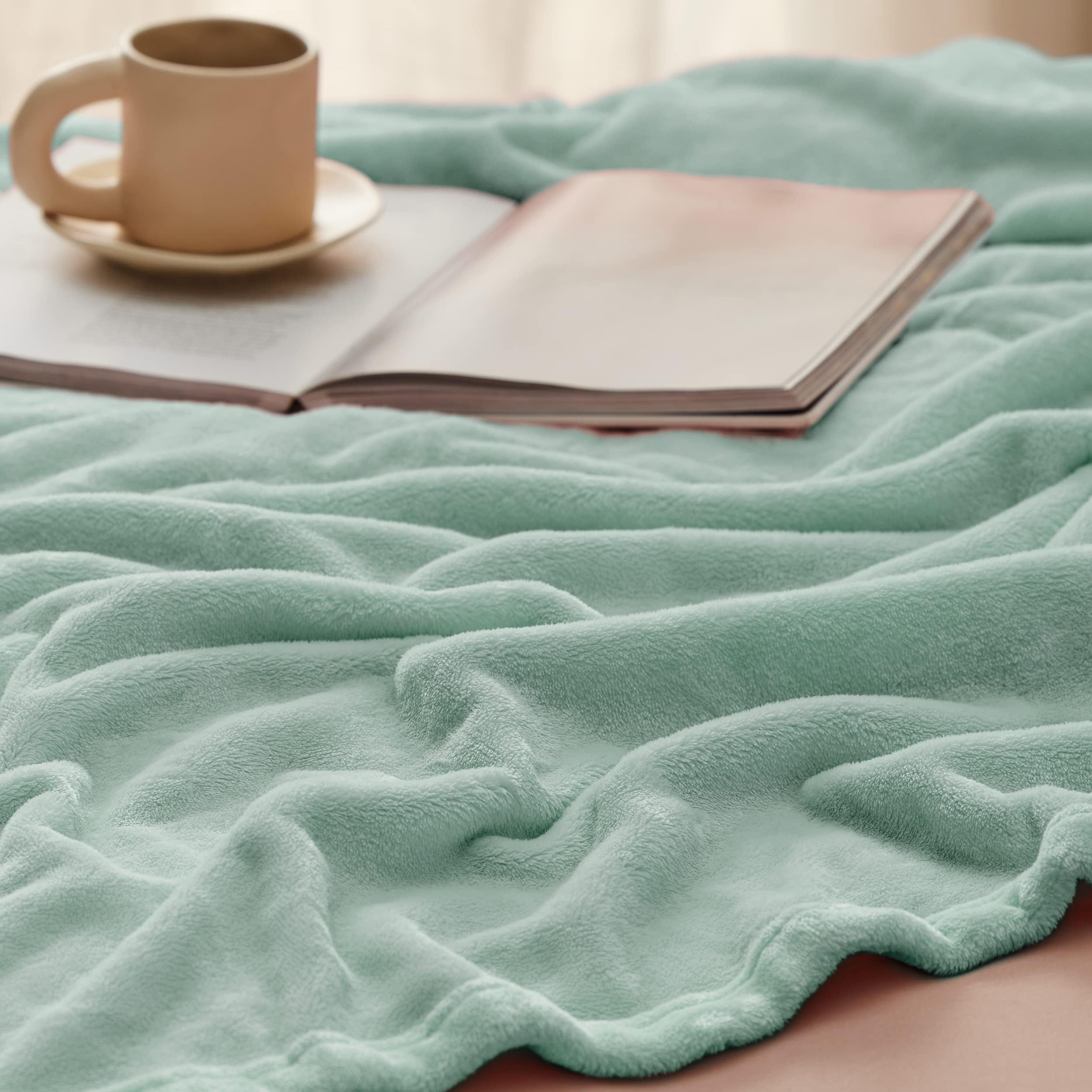 Bedsure blanket draped on a made bed adding cozy style and color coordination