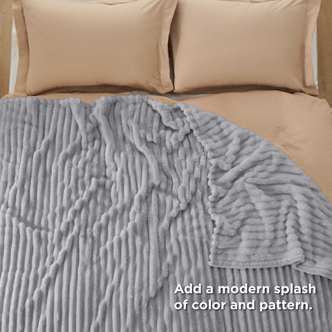 Bedsure blanket draped on couch illustrating versatile use for lounging benefit