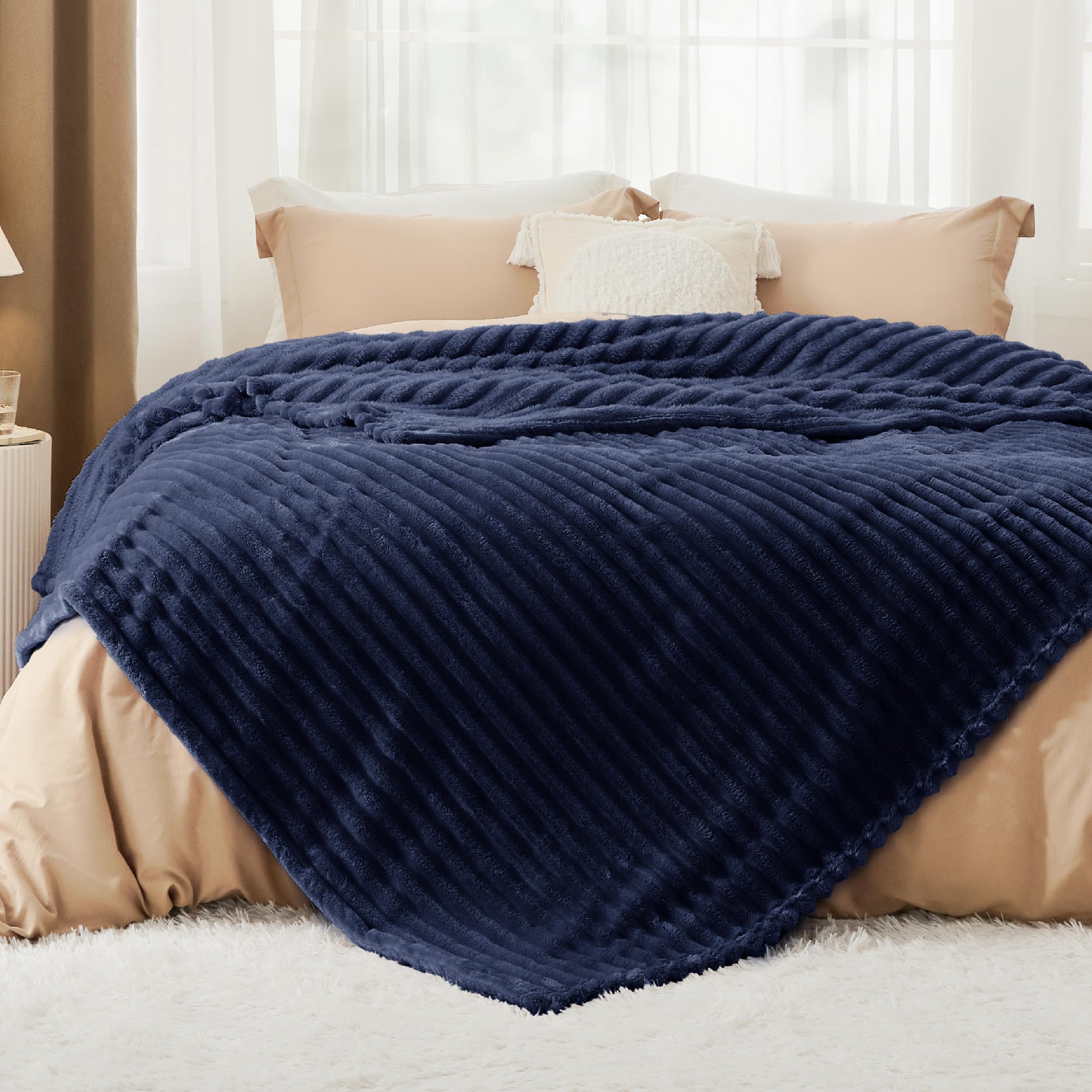 Bedsure navy blanket folded pile detail showing plush fleece and warmth