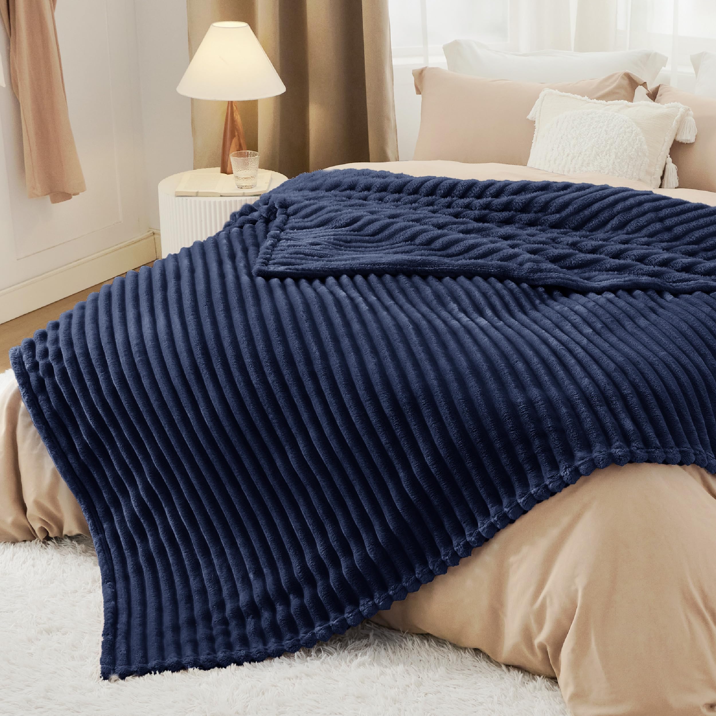 Bedsure navy blanket size comparison on chair showing scale and generous coverage