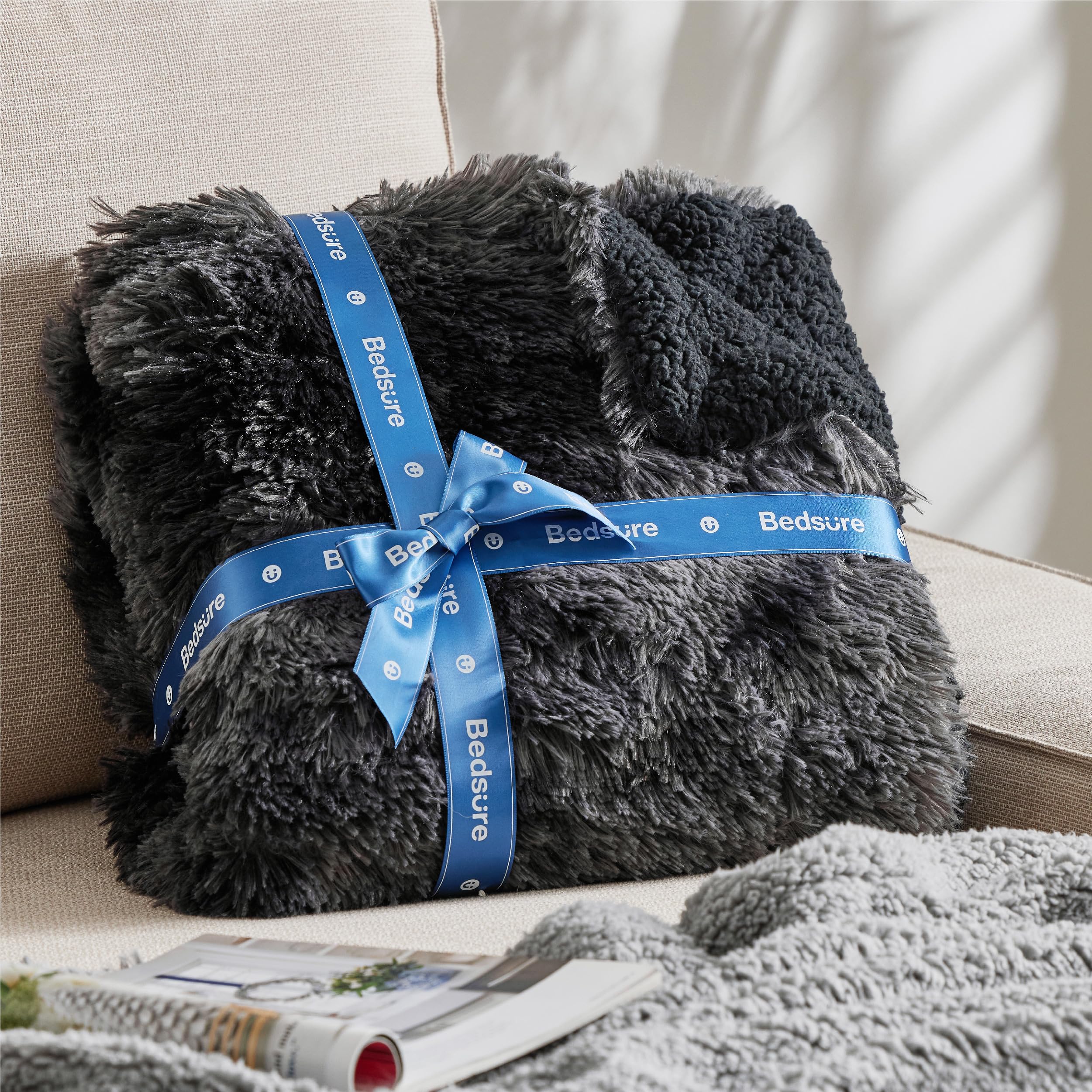 Bedsure with person sitting shows oversized coverage and comfort benefit