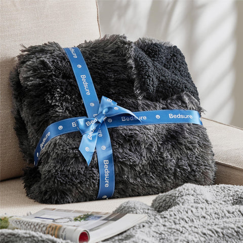 Bedsure with person sitting shows oversized coverage and comfort benefit