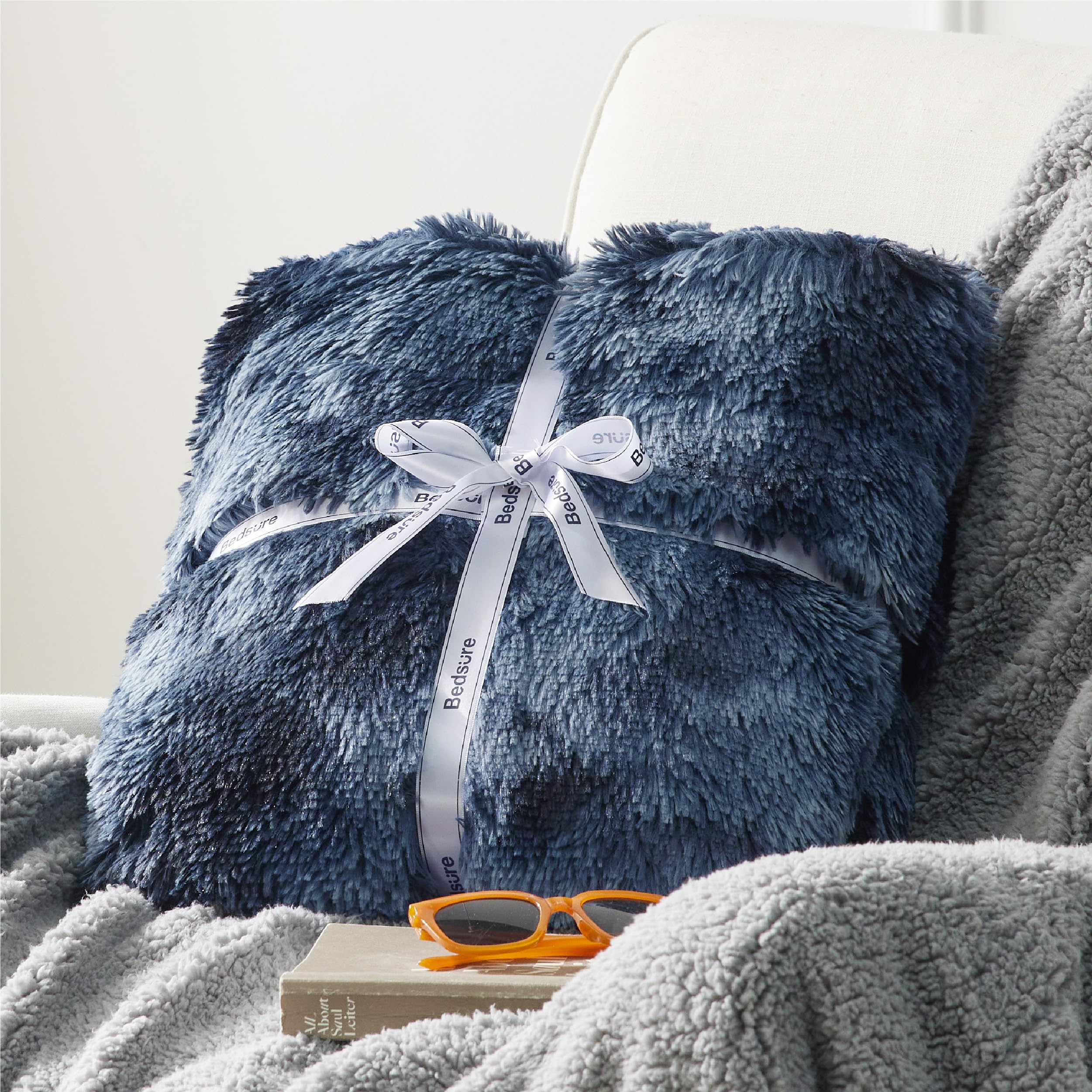 Bedsure blanket on a person highlighting 50x60 scale and travel-friendly warmth
