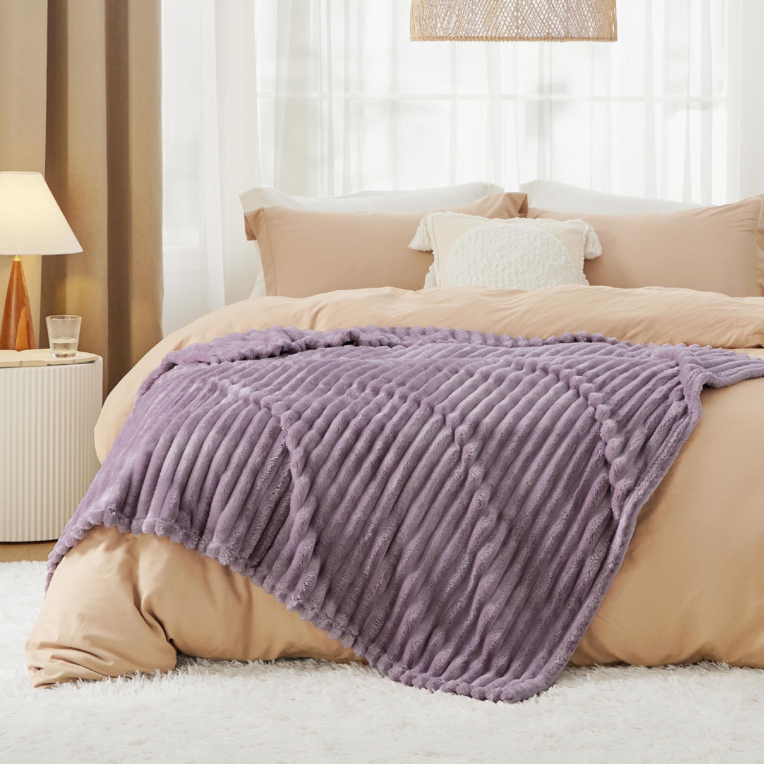 Bedsure throw beside a book showing 50x70 scale for couch or twin use
