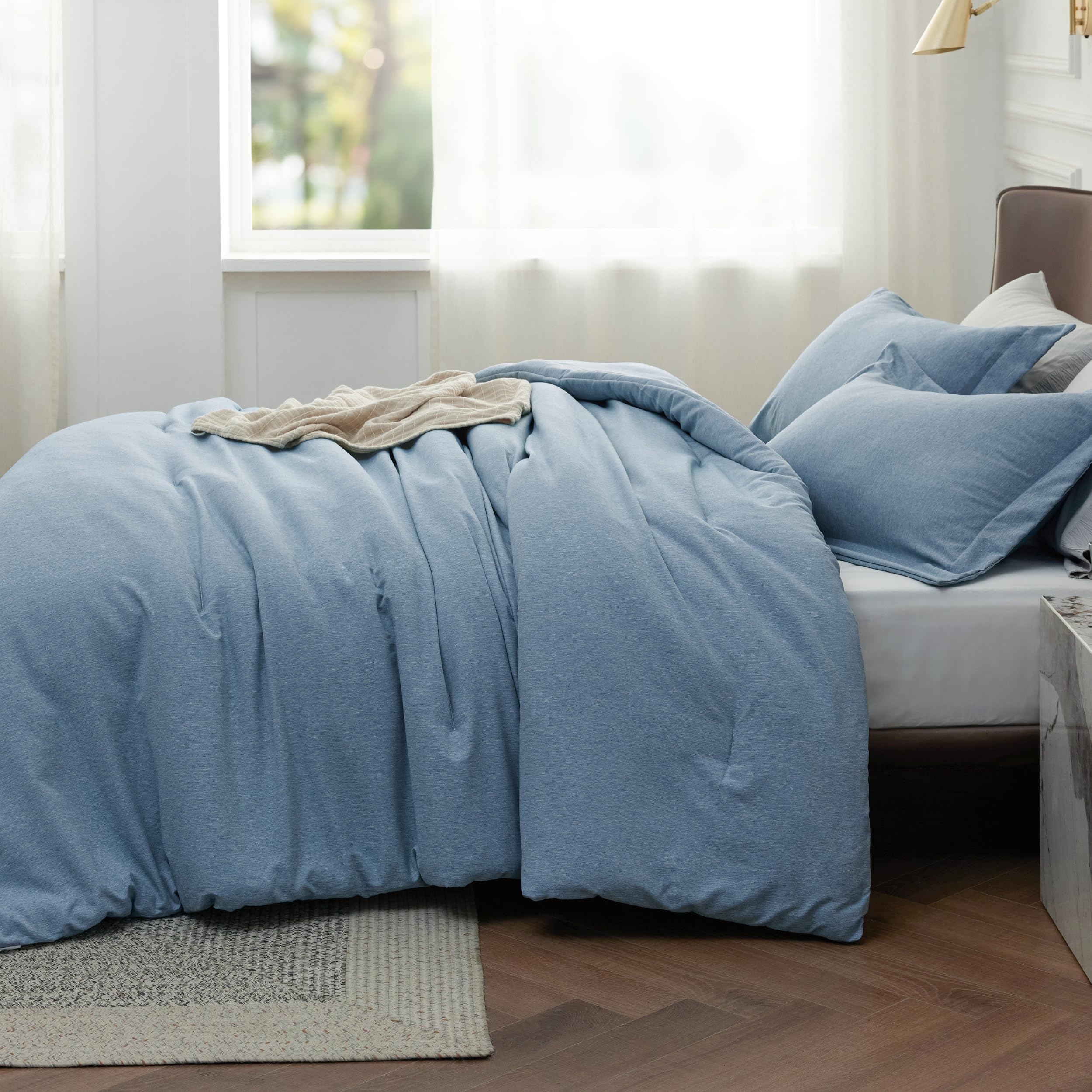 Bedsure Storm Blue comforter on queen bed in a modern bedroom illustrating scale and styling