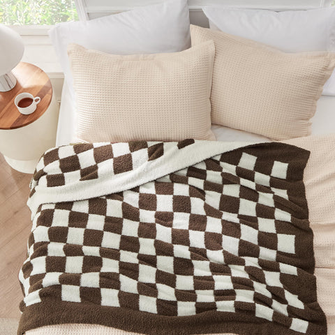 Bedsure throw in use on reading chair providing comfortable lap warmth
