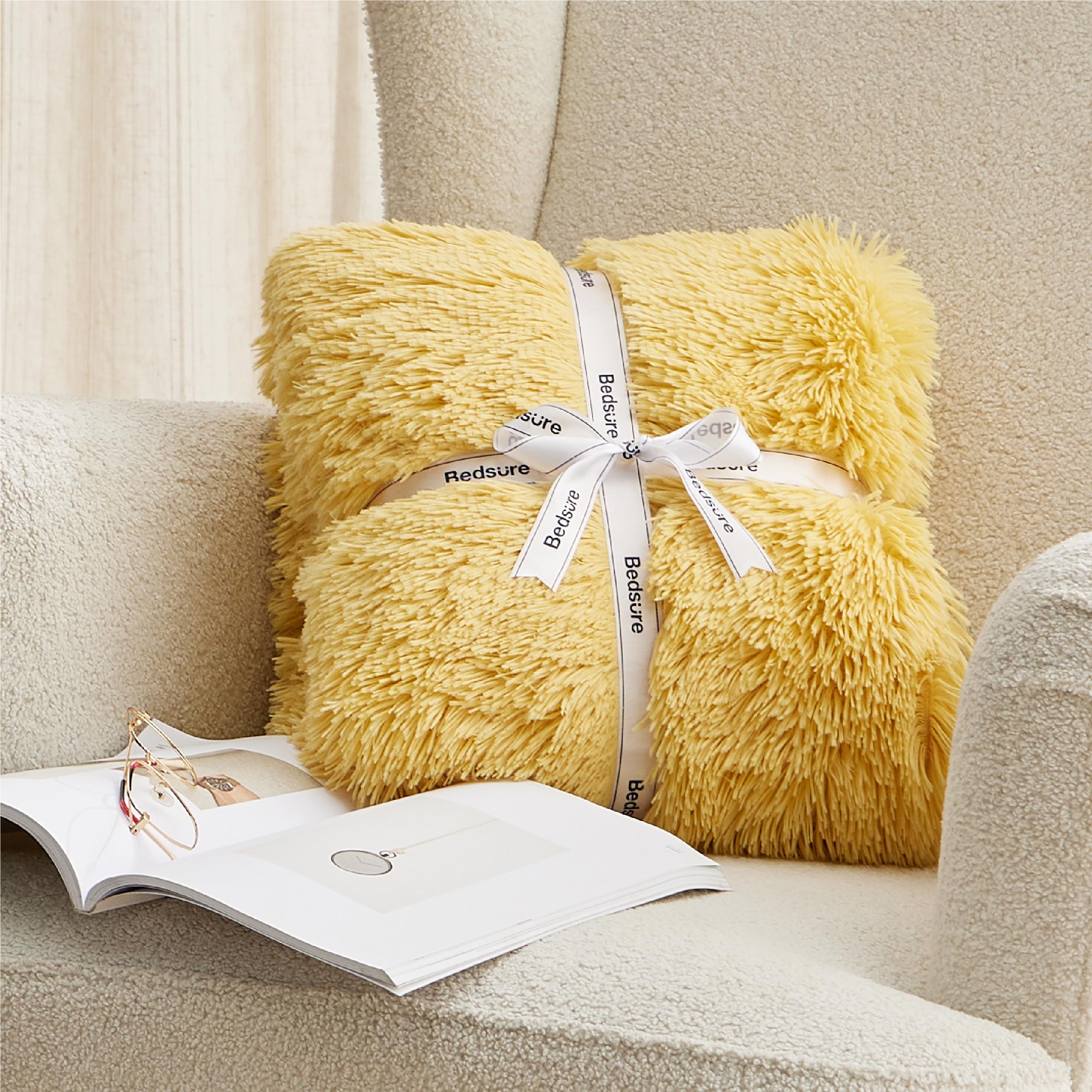 Bedsure throw beside pillow showing scale and generous 60x80 fit