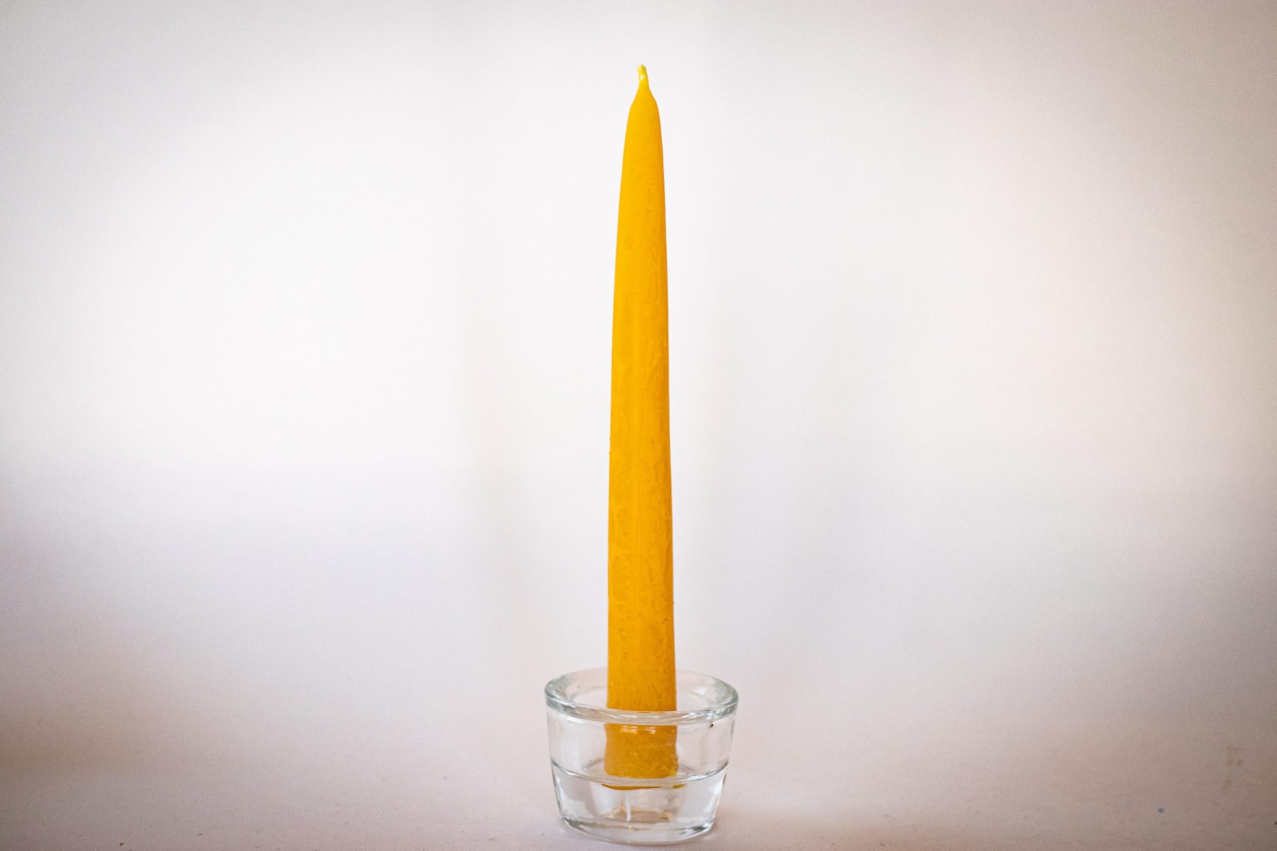 Bee The Light artisan hands dipping tapers demonstrating small-batch care